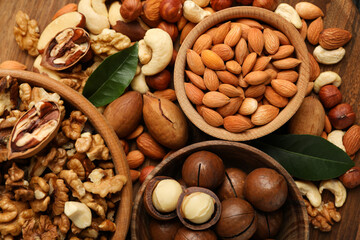 Wooden bowls with different nuts, close up