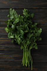 Bouquet of fresh green parsley on wooden background