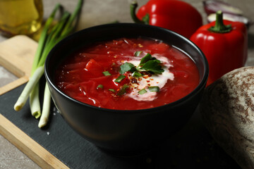 Concept of tasty eating with borscht on gray background