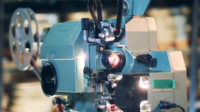 Working old film projector in a detailed view. Vintage movie, old cinema concept.