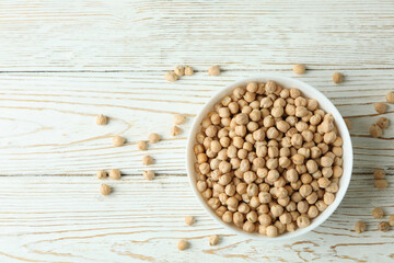 Bowl with chickpea on white wooden table