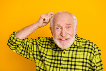 Fototapeta premium Photo of aged man pensioner finger touch head forget memory think isolated over yellow color background