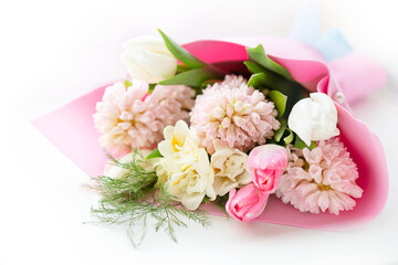 Beautiful bouquet of spring fragrant flowers tulips and hyacinths on a white background. Postcard