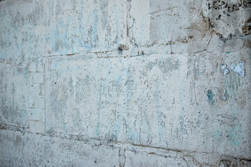 Old shabby wall of large blocks at an angle