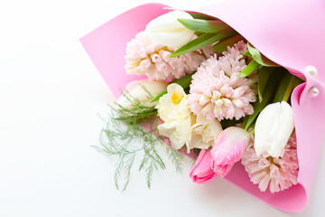Beautiful bouquet of spring fragrant flowers tulips and hyacinths on a white background. Postcard. View from above