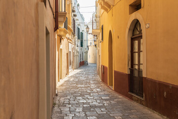 Italy, Apulia, Province of Lecce, Gallipoli. Narrow cobblestone street.