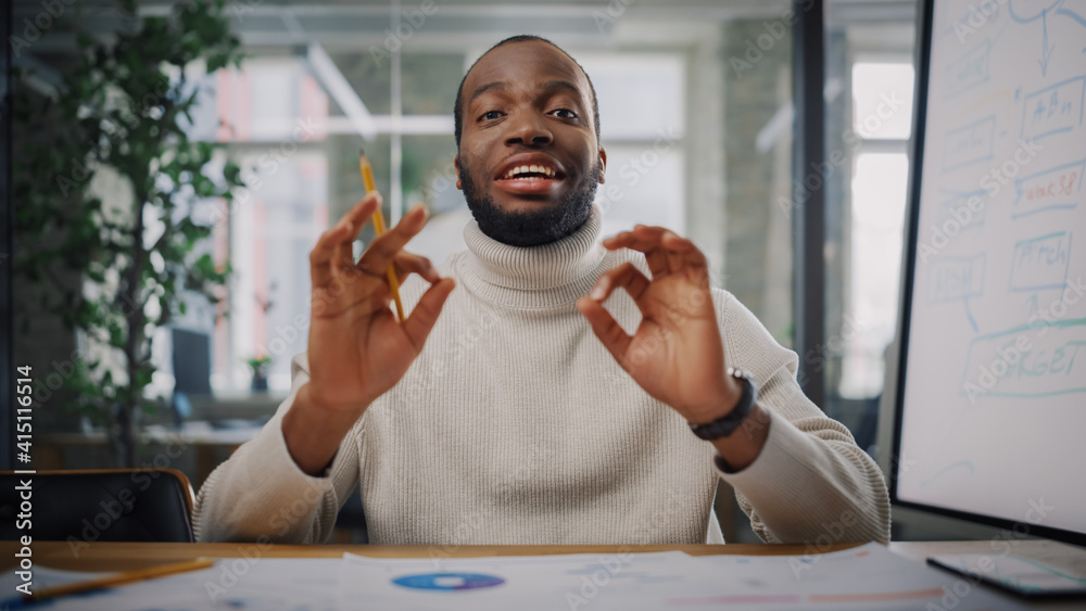 Poster Point of View from Camera with Young Black Project Manager Making a Video Call in Creative Office Environment. Happy African American Male Specialist Showing Ok Gesture to Colleague Over Live Camera.