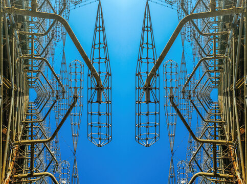 Giant electric antenna against the blue sky and the rising sun