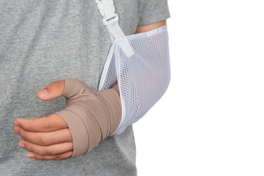 Close up hand with bandage isolate on white background as man arm injury concept and bandage hand arm sling. Asian boy with broken arm or hand dislocation isolated on white background.