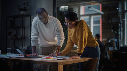 Two Diverse Multiethnic Colleagues Have a Conversation in a Meeting Room Behind Glass Walls in an...