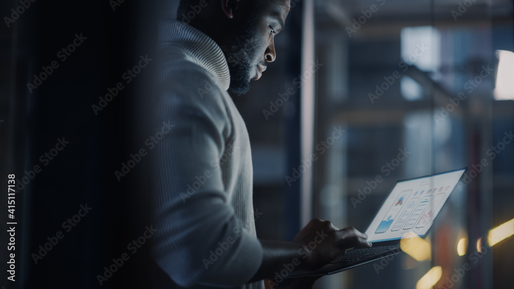 Aufkleber handsome black african american male is standing in meeting room behind glass walls with laptop comp