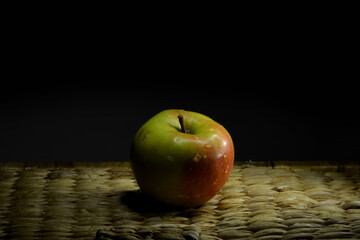 Green apple on a black background