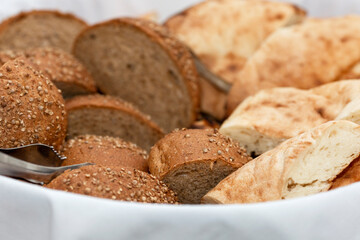 Sliced fresh bread in a basket. Catering for business meetings, events and celebrations. Close-up. Selective focus.