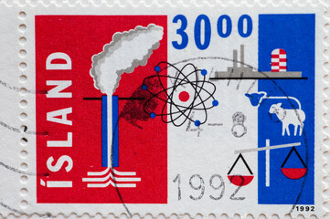 ICELAND- CIRCA 1992: a postage stamp printed in Iceland shown Industry, agriculture and atomic symbols like atomic power plant, chimneys, sheep