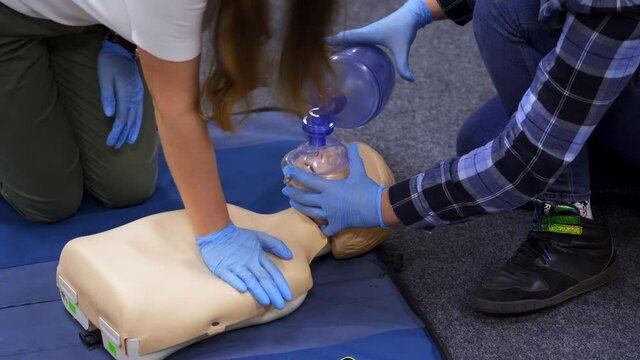 Medical dummy doll lays on blue blanket ready for training. First medical help with oxygen masks. First aid help.