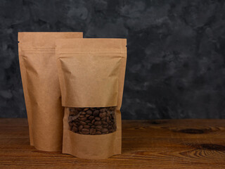 Pouch bag mockup. Blank brown kraft paper pack with coffee beans wooden background advertising copy...