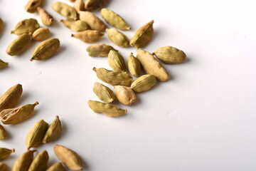 Green cardamom pods on white background