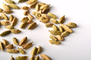 Green cardamom pods on white background