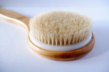 wooden massage brush on white background close
