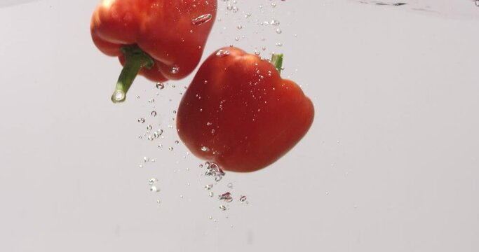 Red bulgarian peppers in the water