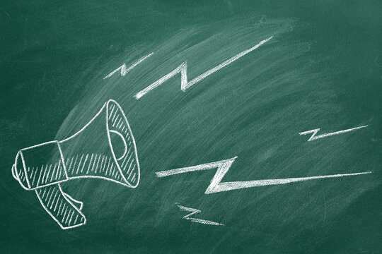 Megaphone hand drawn in chalk on a green chalkboard