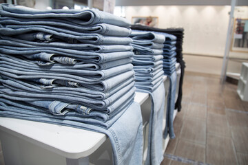 A store that sells jeans. Jeans on the counter of the store.