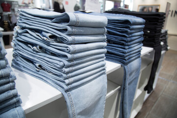 A store that sells jeans. Jeans on the counter of the store.