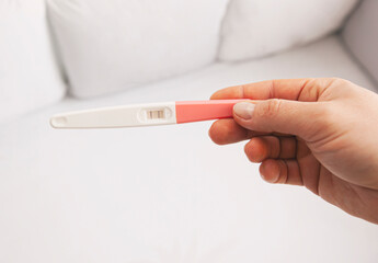 The woman holds the pregnancy test