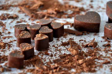 Milk chocolate in big and small hearts with cacao
