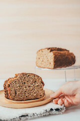 Two slice of freshly backed banana and oaten bread on gray napkin over wooden table. Healthy homemade breakfast. Copy space.