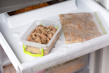 Frozen food in the freezer. Frozen meat, ready meals