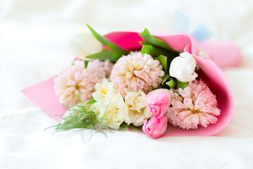 Beautiful bouquet of spring fragrant flowers tulips and hyacinths on a white background. Postcard