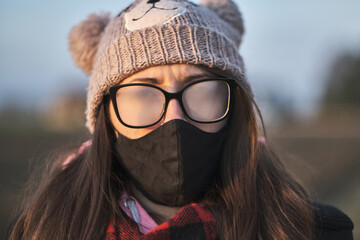 Portrait of a girl with mask and foggy glasses. 
