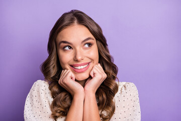 Photo of young attractive beautiful dreamy smiling girl look copyspace hold hands chin isolated on purple color background