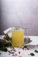 selective focus. Homemade Beef Bone Broth in a glass jar. on a light gray background. with the addition of spices-salt and pepper. Bones contain collagen, which provides the body with amino acids