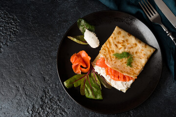 Traditional Russian thin pancakes with filling, red fish and cream cheese