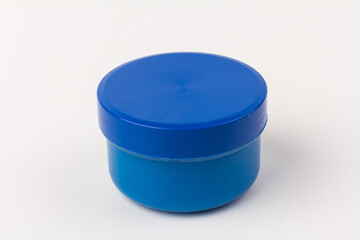 Plastic jars with paint of blue color for children's creativity on white background. Paint bottles for art