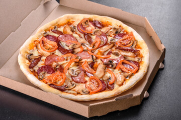 Fresh delicious pizza made in a hearth oven with sausage, pepper and tomatoes