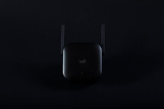 Xiaomi wifi Amplifier Pro in low key. WiFi Aploifier xiami on black background.
