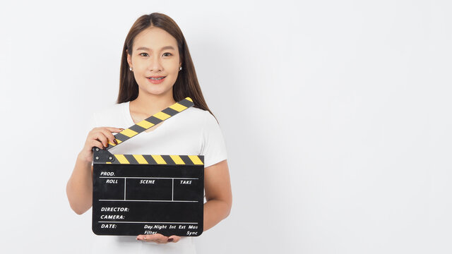 Girl Or Asian Woman Is Holding Black Clapper Board Or Movie Slate Or Clapboard Use In Video Production ,film, Movie,cinema Industry On White Background.