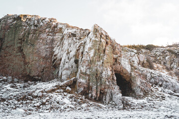 Fototapeta na wymiar Cave entrance on the Swedish west coast during wintertime. Nature background.