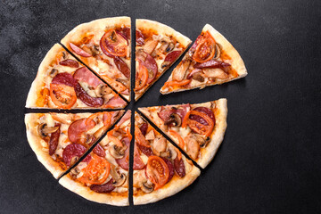 Fresh delicious pizza made in a hearth oven with sausage, pepper and tomatoes