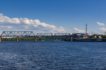 Railway bridge across the river on which the train is traveling