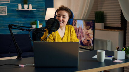Influencer wearing headphones recording new podcast series for audience. On-air online production...