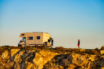 Camper camping on cliff rock, Spain