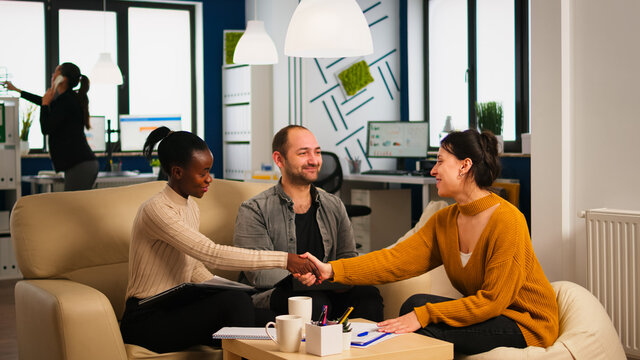 Diverse business people shaking hands, consultant greeting international clients with handshake and planning partnership deal with executive meeting shareholders in start up corporate office