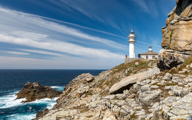 Fototapeta na wymiar lighthouse on the atlantic death coast with blue sky and clouds