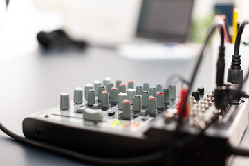 Close up of professional mixer in vlogger home podcast studio. Social media influencer recording professional content with modern equipment and digital web internet streaming station