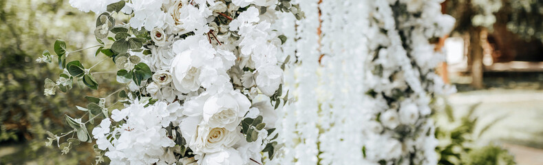 Arch decor with white flowers for a wedding ceremony in nature