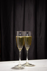Champagne glasses on a dark background. The concept of the celebration.